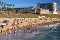 A crowd enjoys the ocean waters